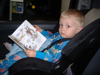 Tristen reading in his carseat.